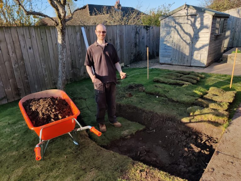 Rob stood in the new hole in the lawn